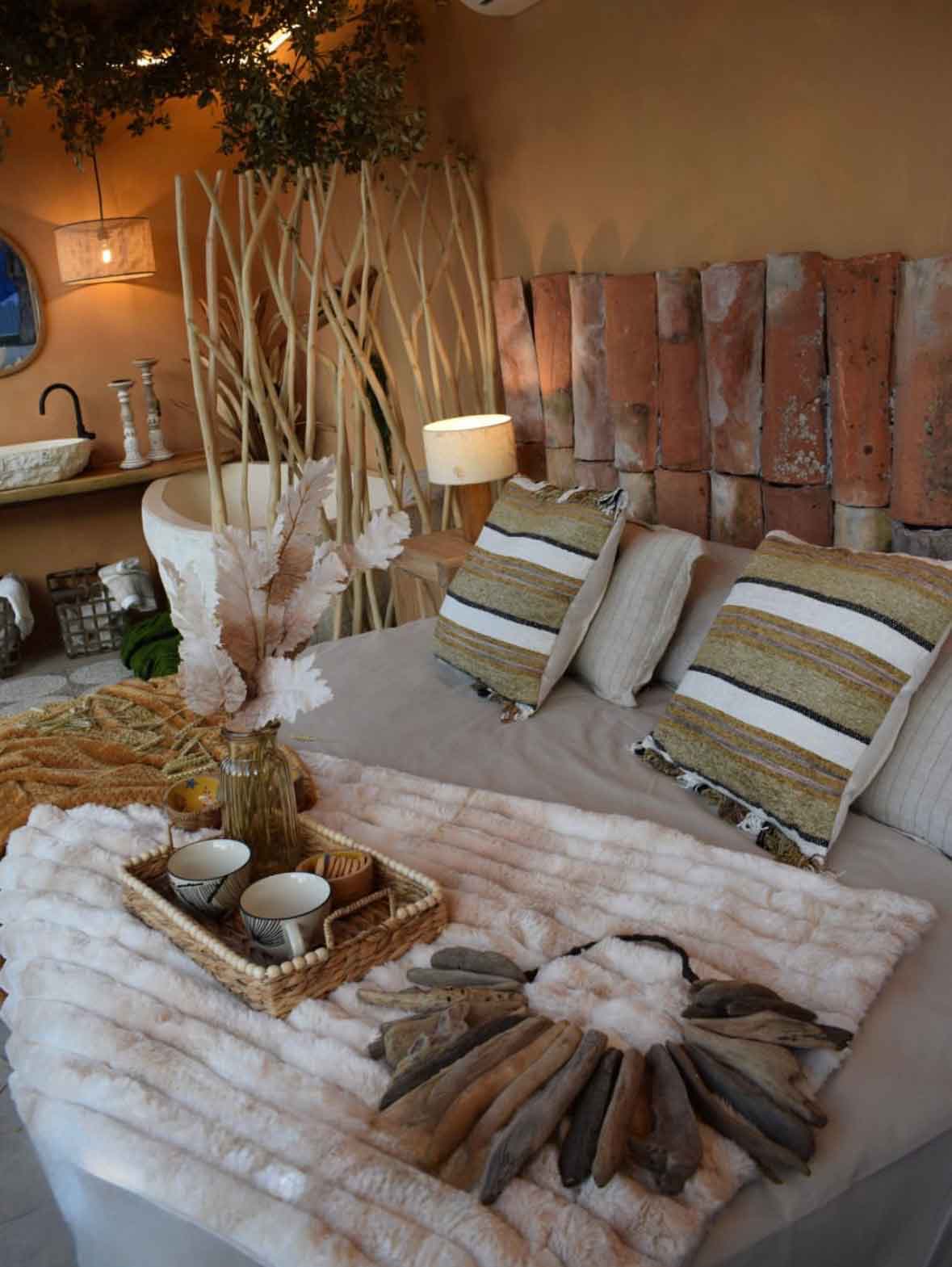 dormitorio wabi-sabi en Burgos con cabecero de ladrillo, separador de ramas y techo verde de inspiración biofílica
